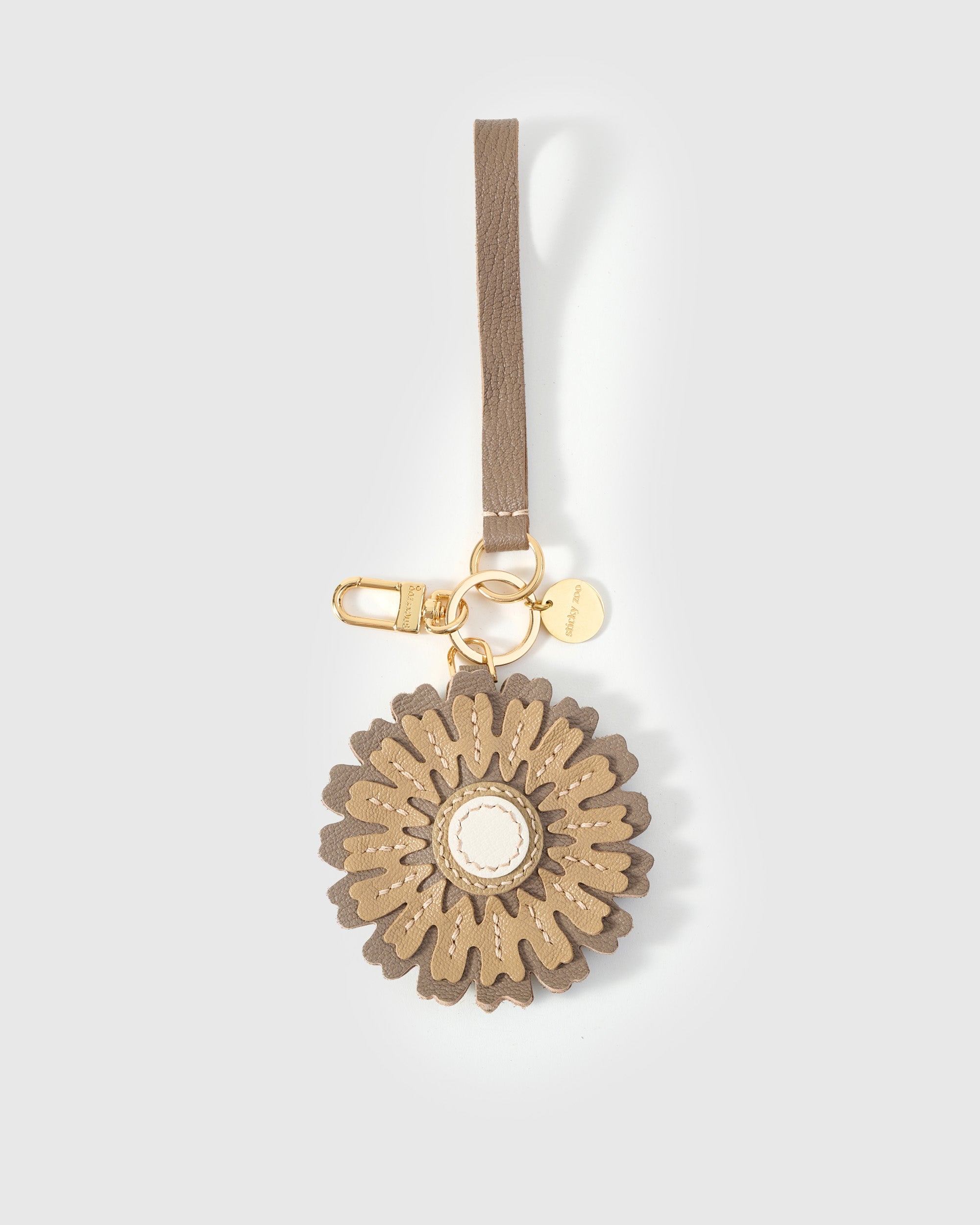 STICKYZOO Sunflower Charm in cream and olive over brown French Alran goatskin. Hand-cut, hand-stitched. Designed in Amsterdam.