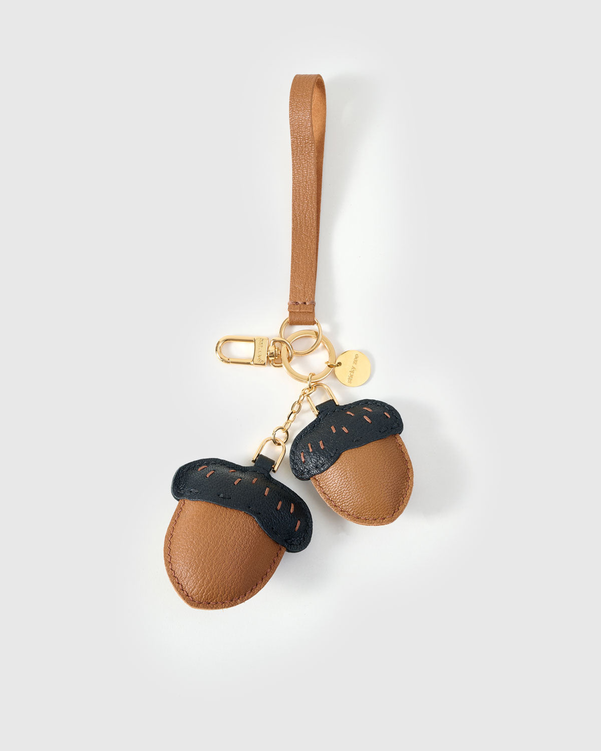 STICKYZOO Acorns Charm in warm tan with dark navy caps French Alran goatskin. Hand-cut, hand-stitched. Designed in Amsterdam.