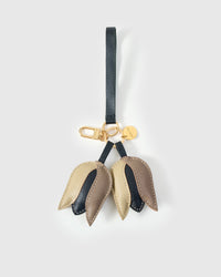 STICKYZOO Tulip Charm in gold, taupe, and dark French Alran goatskin. Hand-cut, hand-stitched. Designed in Amsterdam.
