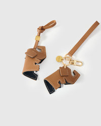 Both editions of the elephant charm — leather strap loop for bags, or 18K gold-plated keychain clip.
