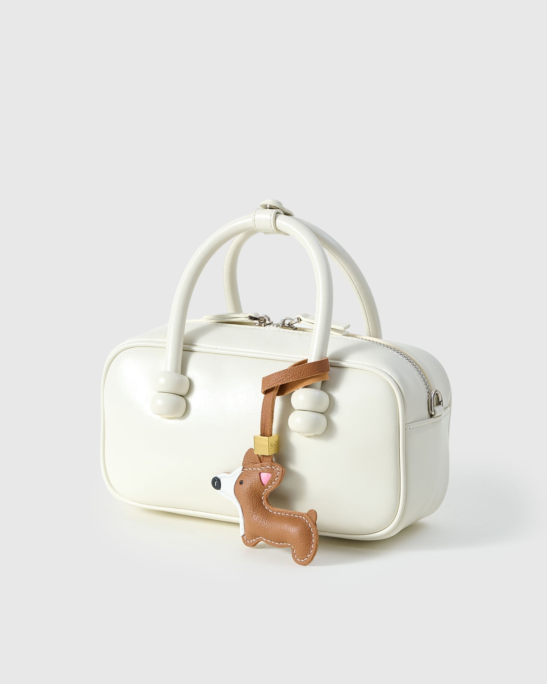 Wear the Pembroke Welsh Corgi charm on a bag with the leather strap loop, or clip it to keys with the 18K gold-plated keychain clip.