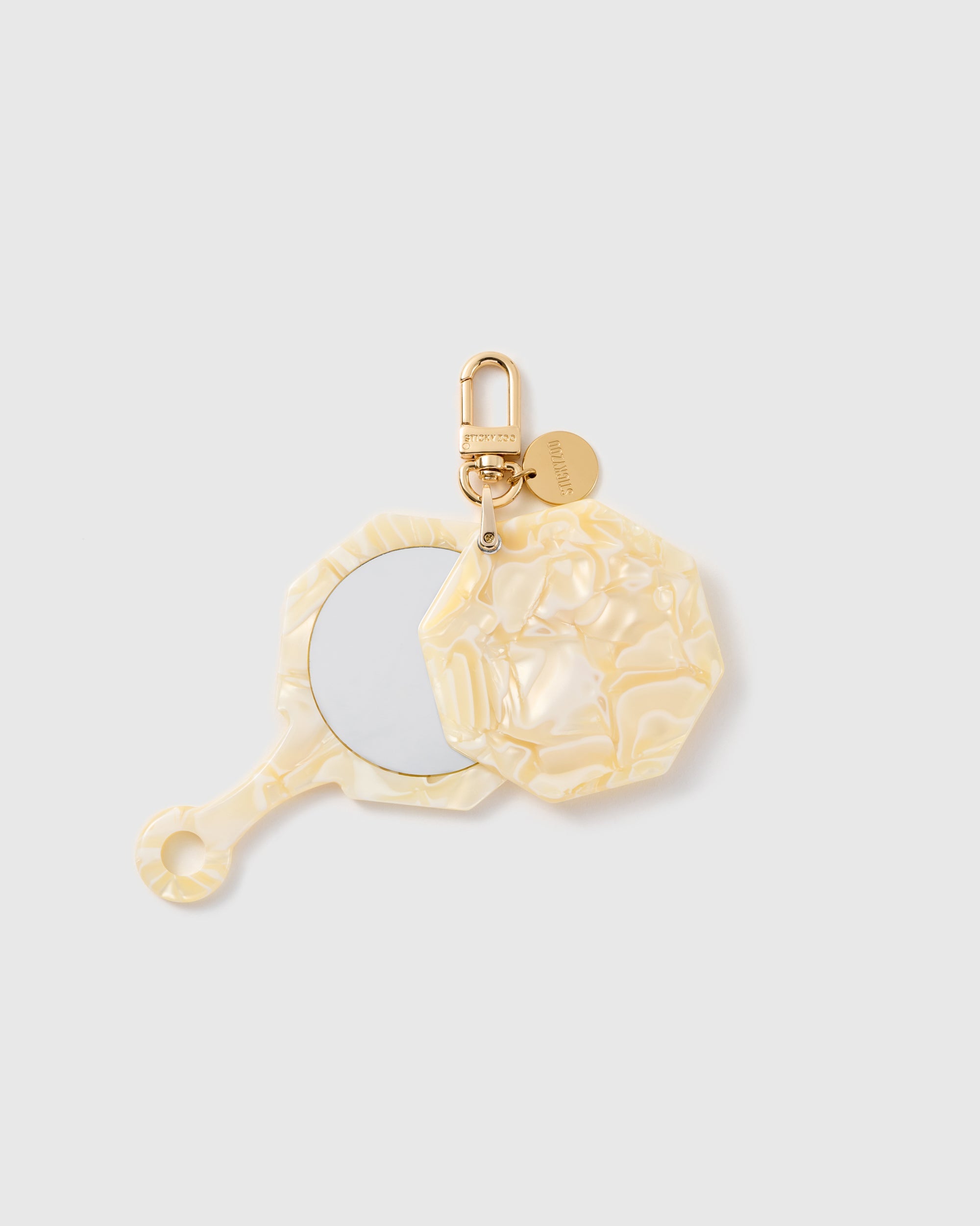STICKYZOO Eloise Moon Glow Mirror Charm open to reveal the compact mirror beneath its pearlescent beige cover.