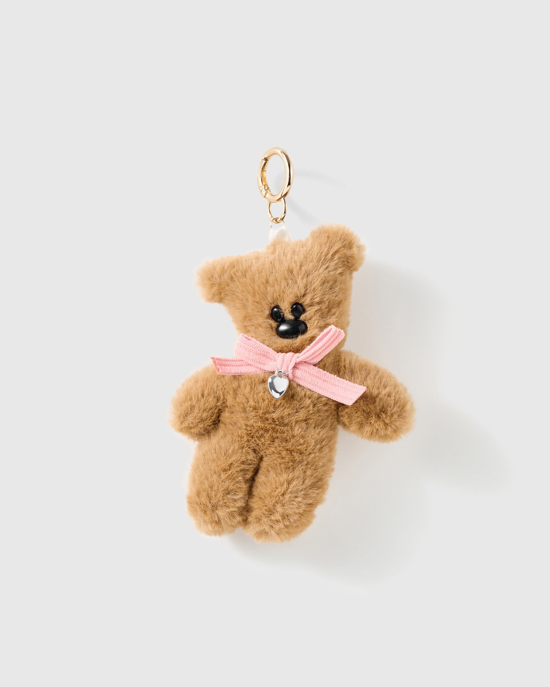Pink Bow Teddy Plush Charm with the soft tan body is finished with a pale pink neck bow and a small heart-shaped centre detail on a light background