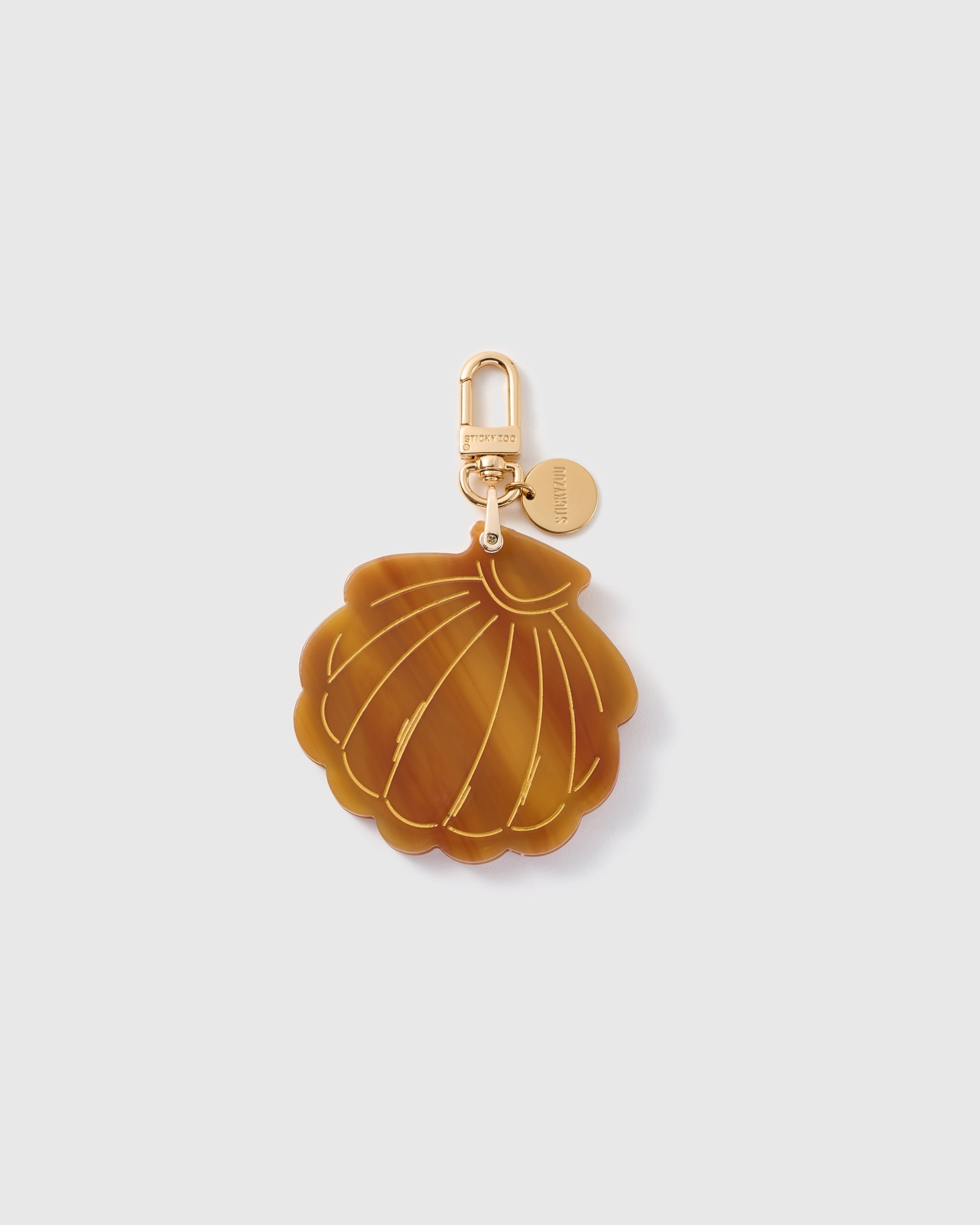STICKYZOO folding shell mirror charm in Brown with patterned surface, gold-tone linework and branded clasp.