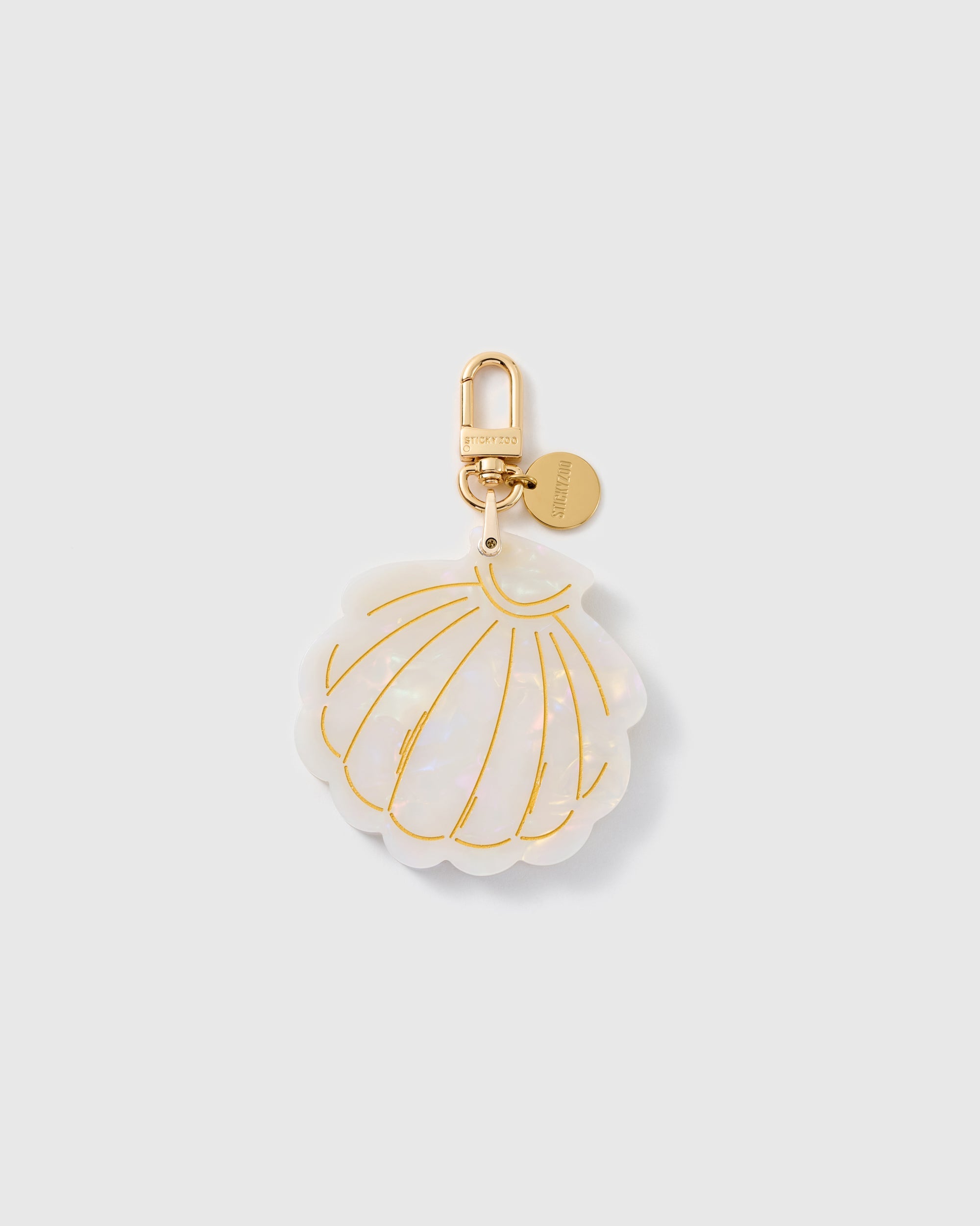 STICKYZOO folding shell mirror charm in Cream with pearlescent surface, gold-tone linework and branded clasp.