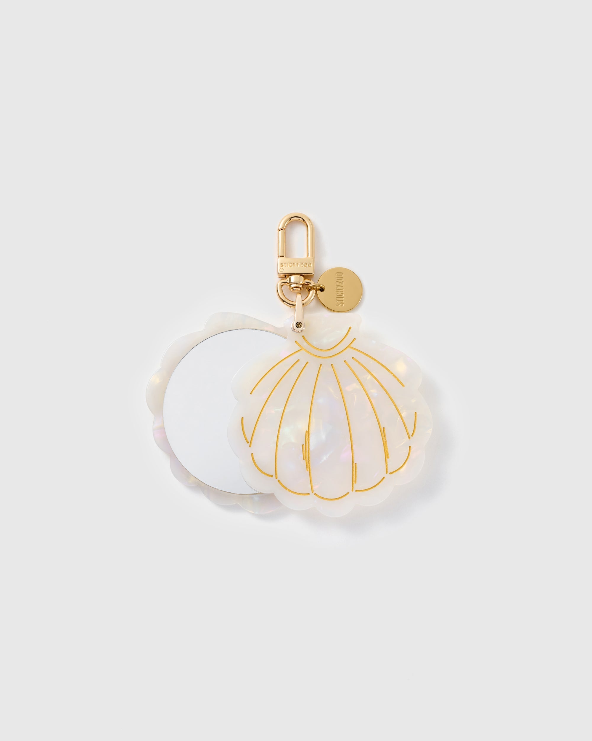 STICKYZOO Serena Moon Shell Mirror Charm open to reveal the compact mirror beneath its pearlescent cream cover.