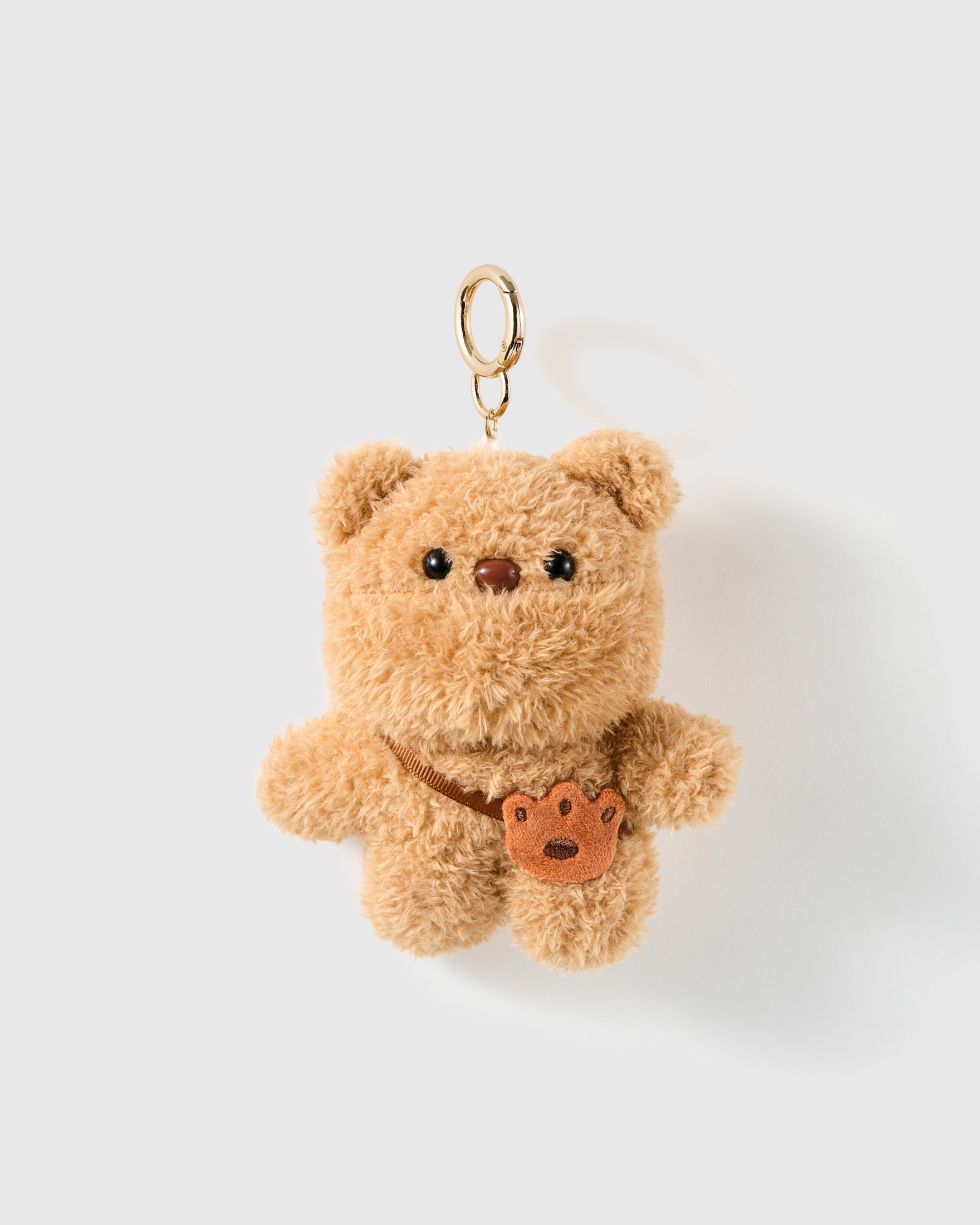 Teddy Paw Plush Charm with a warm tan plush body and small brown paw detail make the bear feel playful without extra decoration on a light background