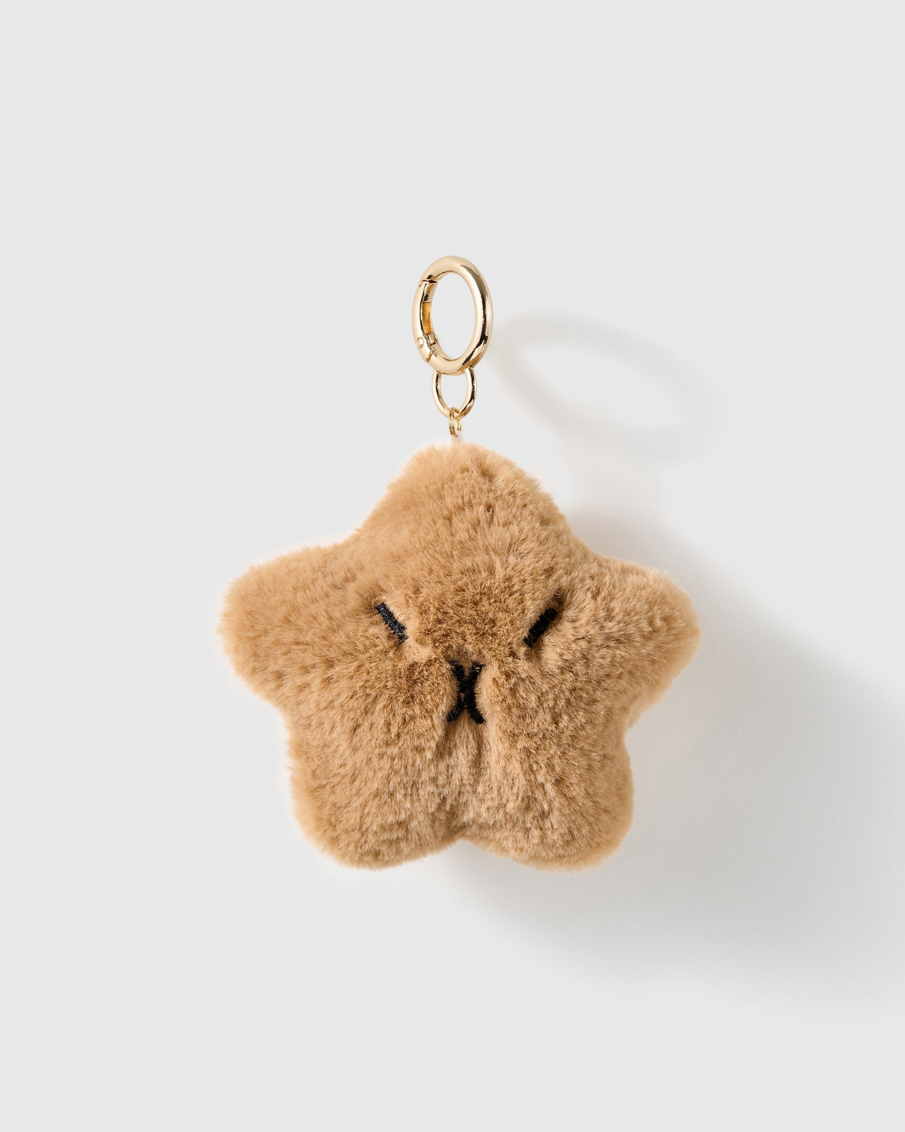 Grumpy Star Plush Charm with five soft points and a tiny embroidered frown give the star more personality than sparkle on a light background