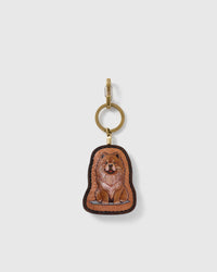 STICKYZOO Mabel Chow Chow Daydream charm with a seated tan, chestnut and cream full-body portrait, dark stitched border, and gold-tone ring-and-clip hardware on a pale background
