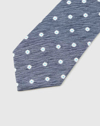 Slate Daisy Tie blade detail showing hand-embroidered small daisy blossoms and silk texture by STICKYZOO