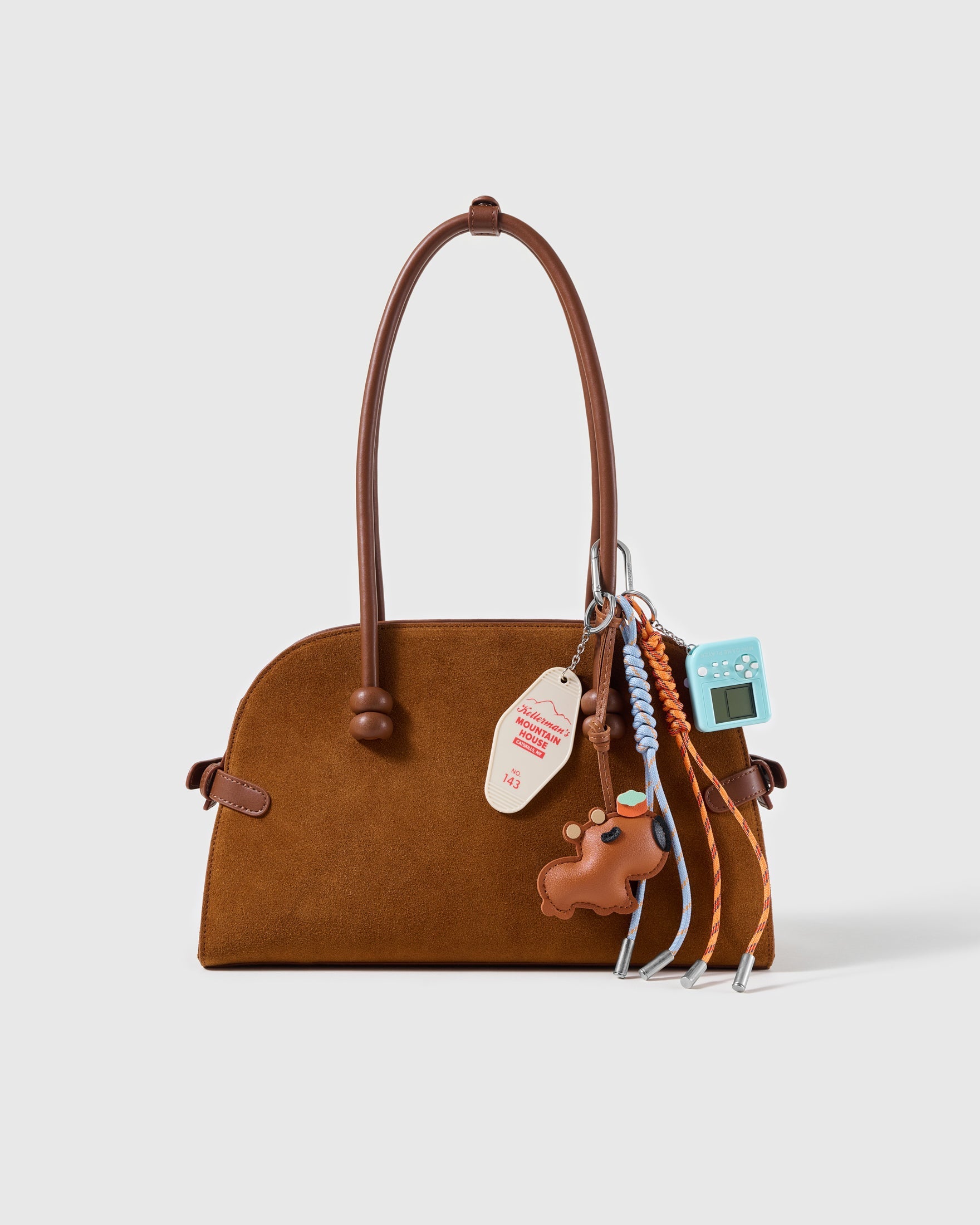 Dachshund Arcade Message Stack Charm attached to a structured handbag to show the complete design