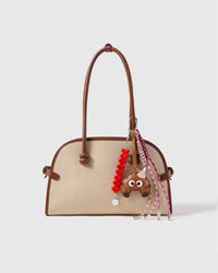 Sweet Ride Heart Stack Charm attached to a structured handbag to show the complete design
