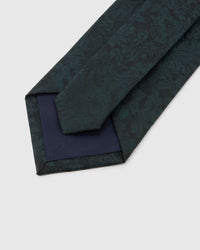 Forest Shadow Floral Tie detail showing tonal shadow florals and foliage, raised thread and the tactile deep forest teal silk surface.