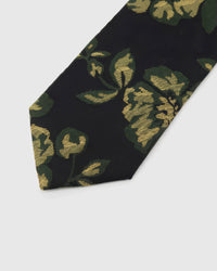 Noir Golden Rose Tie detail showing golden roses with deep-green leaves, raised thread and the tactile noir silk surface.