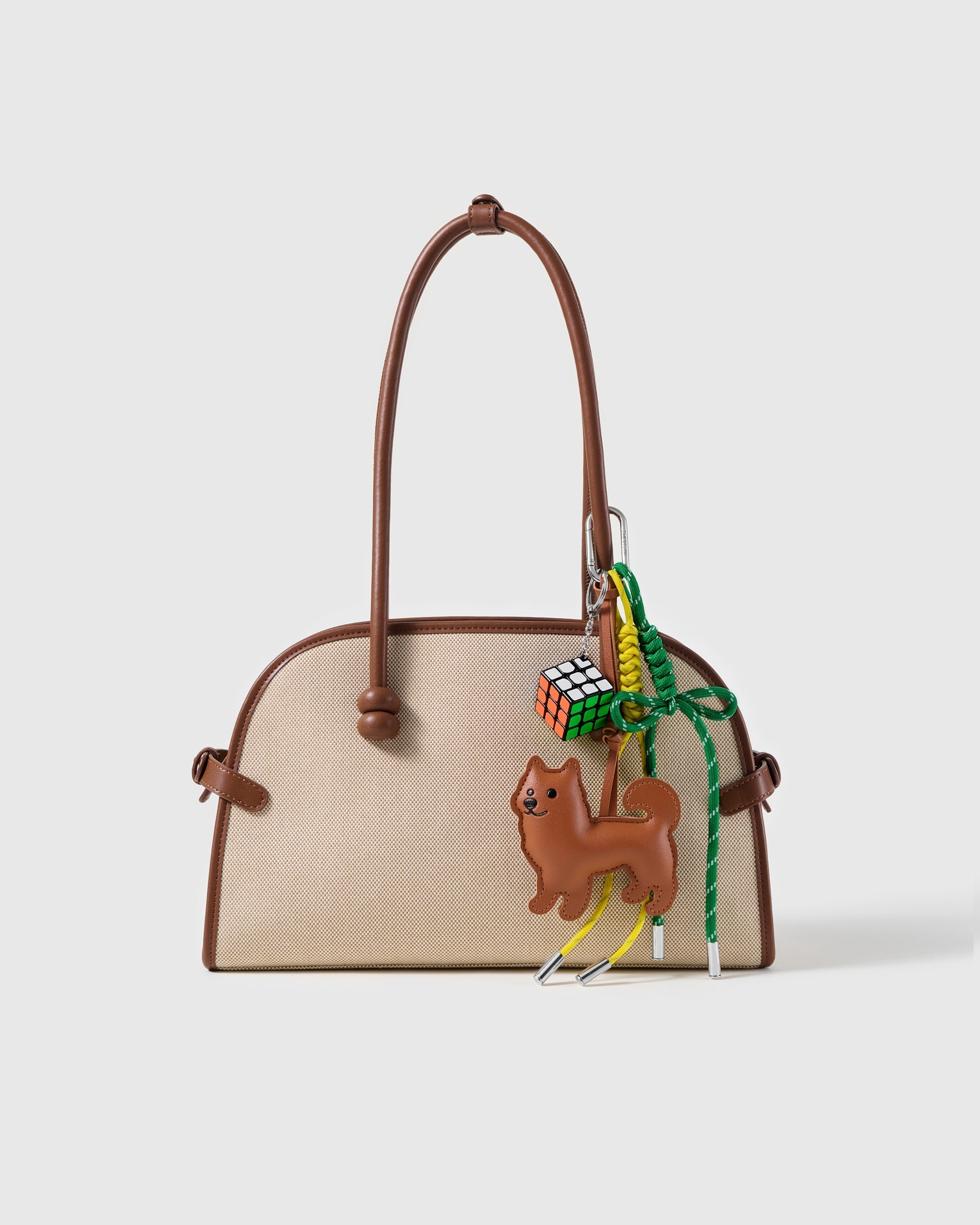 Shiba Puzzle Stack Charm attached to a structured handbag to show the complete design