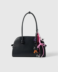 Black Cat Bow Stack Charm attached to a structured handbag to show the complete design