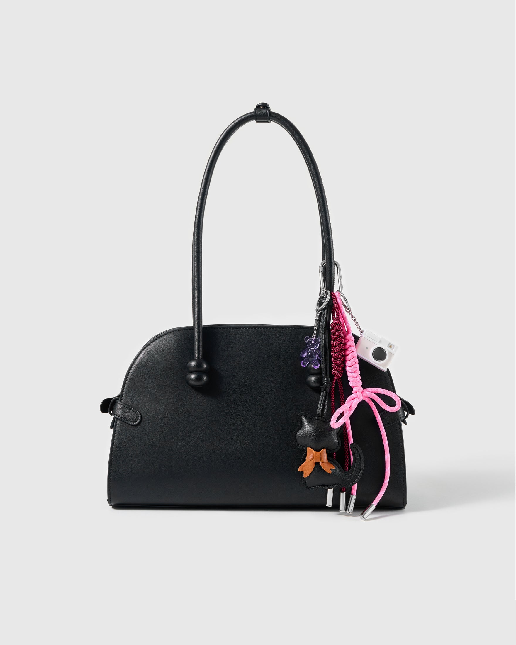 Black Cat Bow Stack Charm attached to a structured handbag to show the complete design