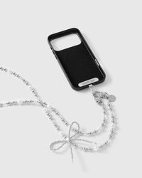 Frost Bow cross-body phone strap attached to a black phone case with dual clasps and the included Phone Strap Card.