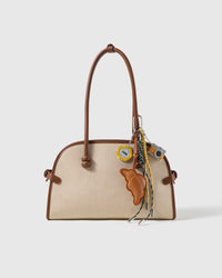 Croissant Lucky Camera Stack Charm attached to a structured handbag to show the complete design