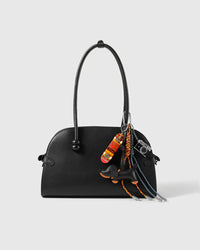 Dachshund Skate Stack Charm attached to a structured handbag to show the complete design