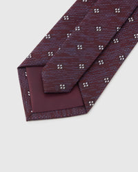 Claret Four-Dot Tie detail showing claret crosshatch with white four-dot clusters and the tactile silk surface.