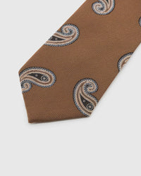 Cognac Paisley Tie detail showing black, cream, and brown paisley, raised thread and the tactile cognac silk surface.