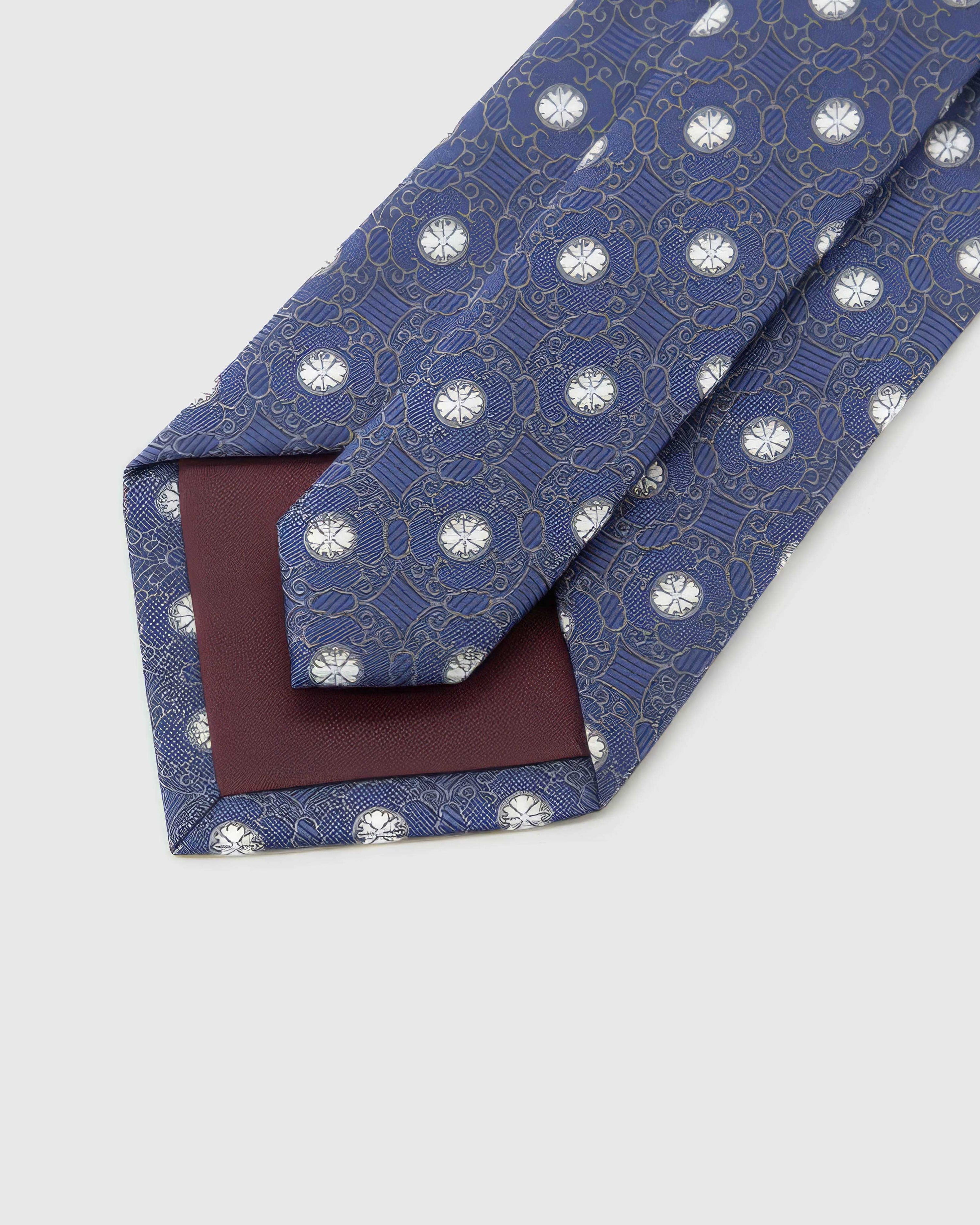 Back of STICKYZOO Indigo Rosette Tie showing burgundy structured interlining, hand-finished folds and keeper, 145 × 8 cm