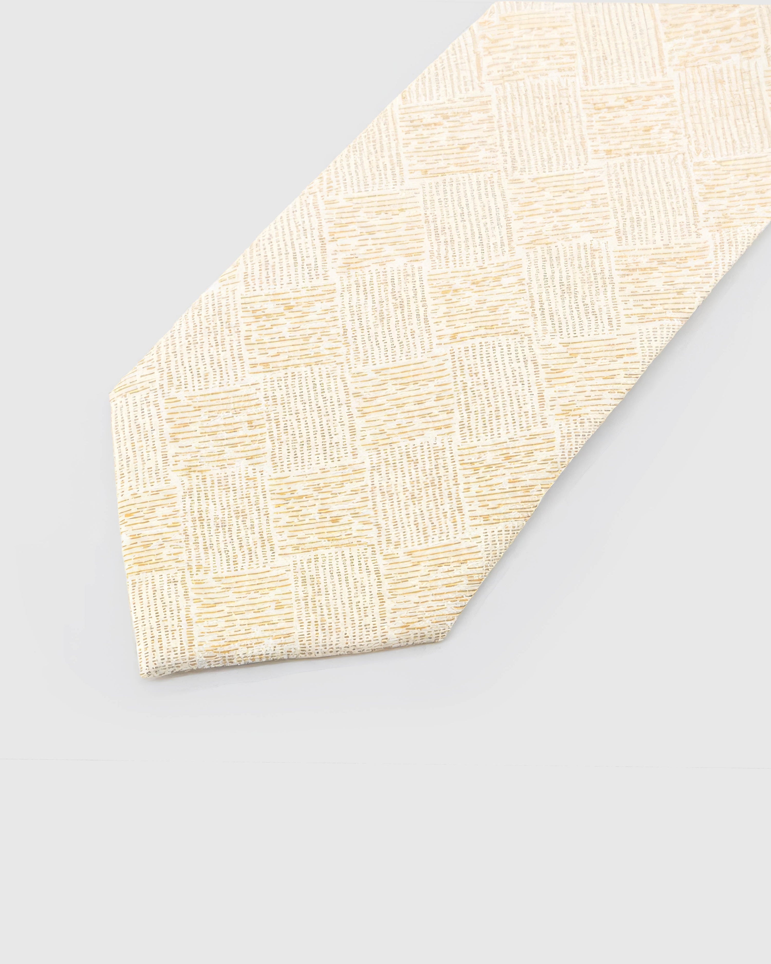 Ivory Gilded Grid Tie detail showing pale-gold irregular grid, raised thread and the tactile ivory silk surface.
