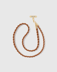 Full-length hand-braided cognac phone strap shown with gold-plated hardware and included Phone Strap Card