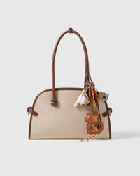 Cocoa Cat Camera Stack Charm attached to a structured handbag to show the complete design
