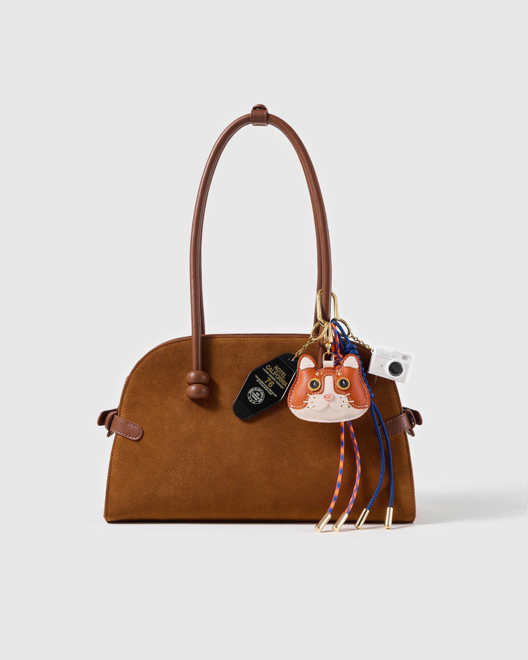 Camera Cat Stack Charm attached to a structured handbag to show the complete design