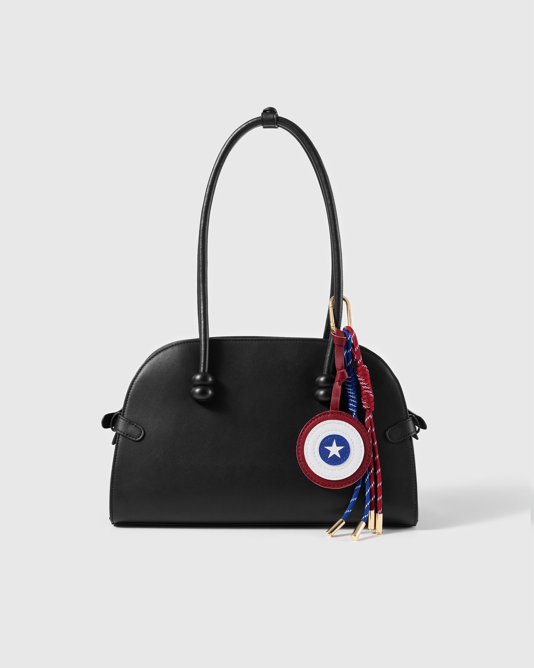 STICKYZOO Star Shield Stack Charm clipped to a black handbag