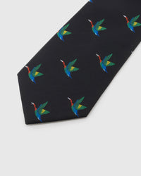 Noir Crane Tie detail showing noir ground with colourful flying cranes and the tactile silk surface.