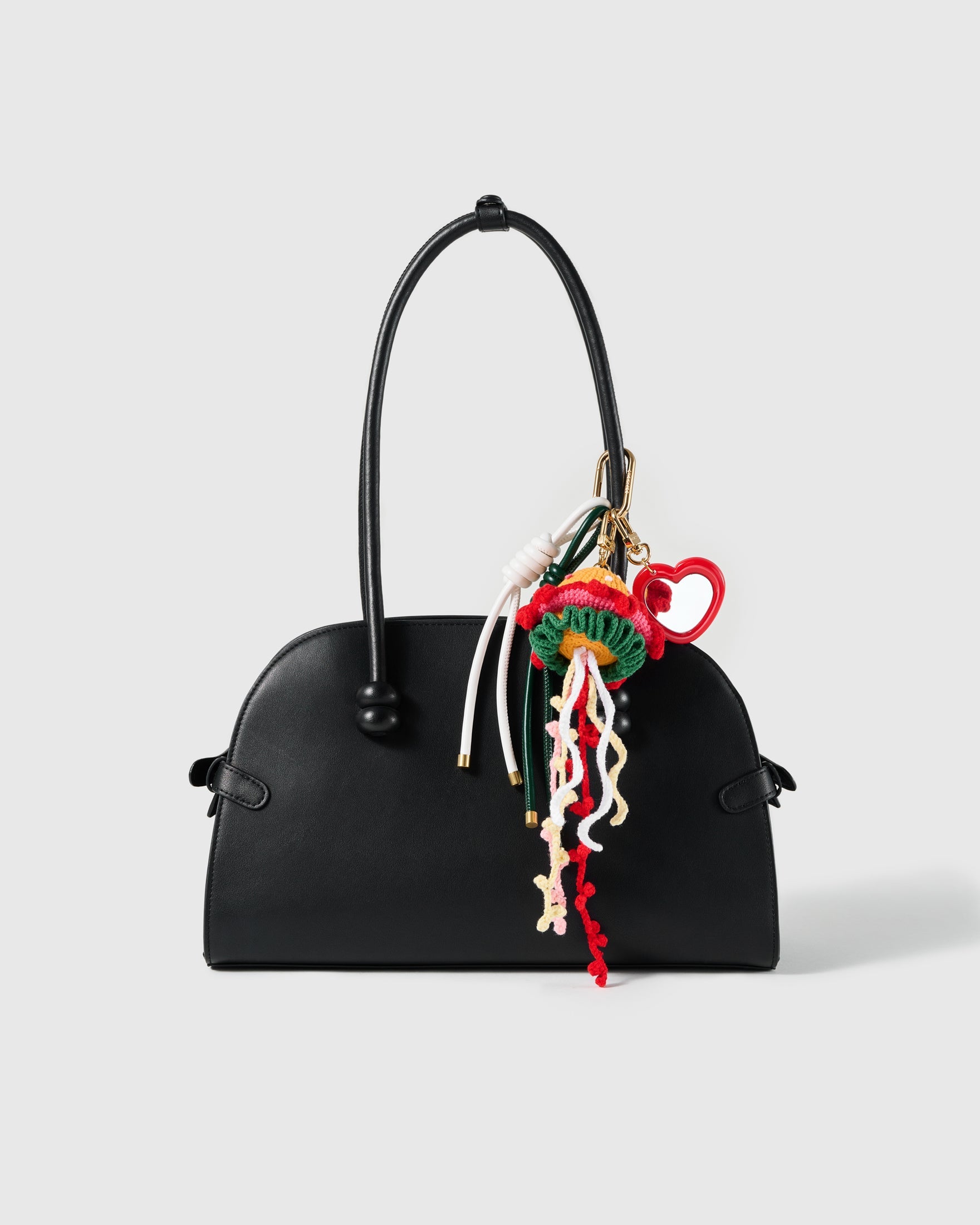Burger & Noodles Gold Stack Charm attached to a structured handbag to show the complete design