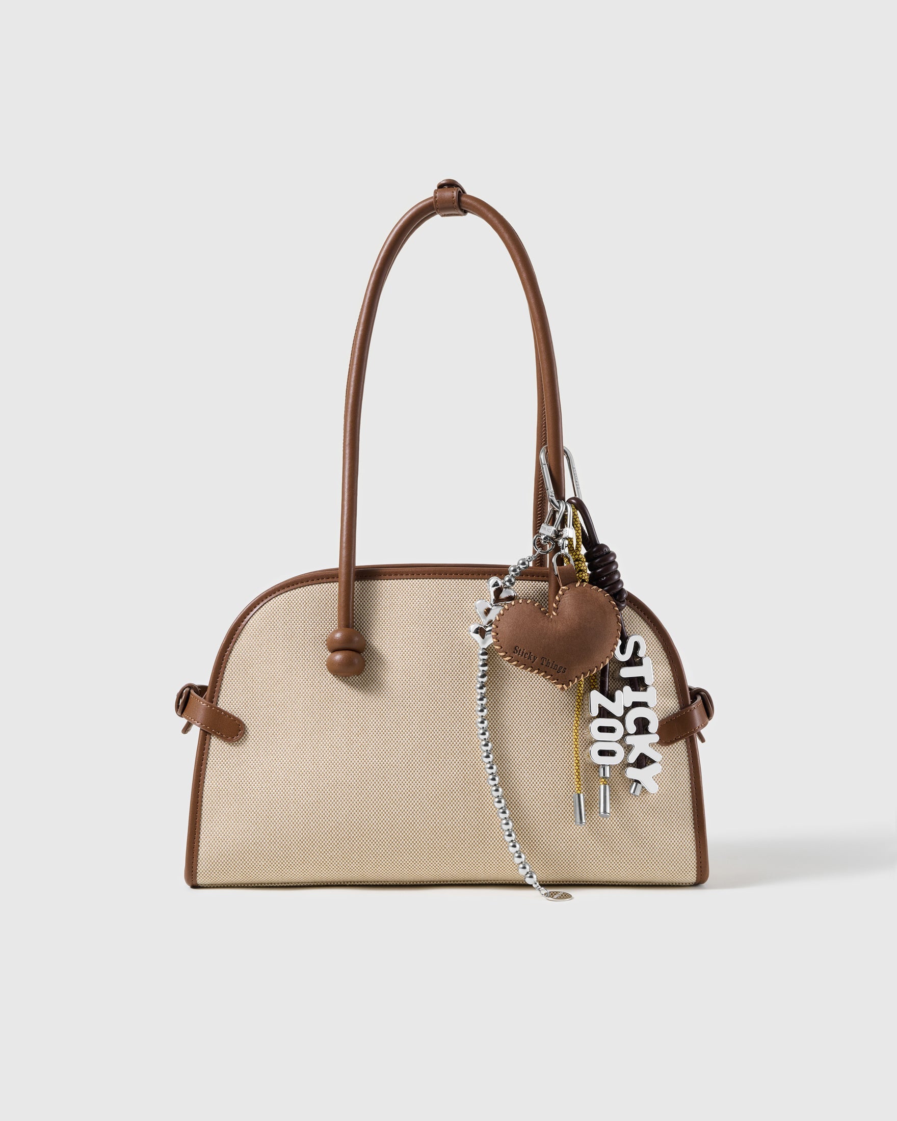 Love Letter Heart Stack Charm attached to a structured handbag to show the complete design