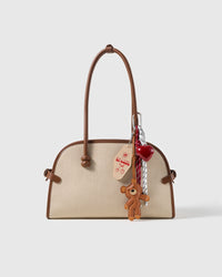 Teddy Heart Message Stack Charm attached to a structured handbag to show the complete design