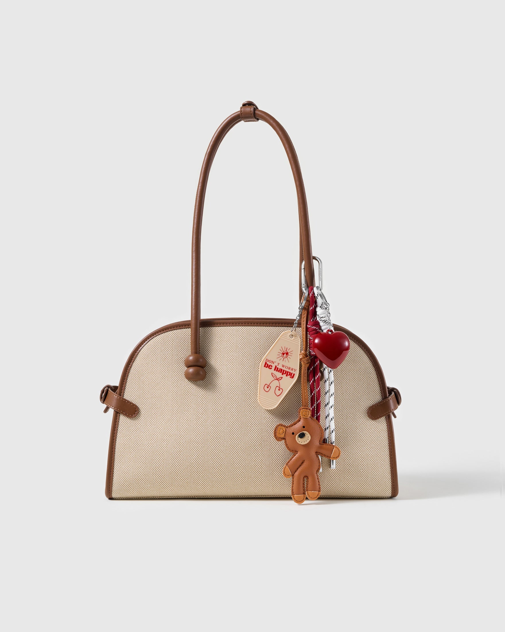 Teddy Heart Message Stack Charm attached to a structured handbag to show the complete design