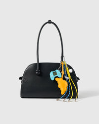 Croissant Golf Stack Charm attached to a structured handbag to show the complete design