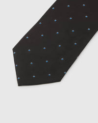 Noir Blue Icon Tie detail showing noir ground with small cobalt, azure and white abstract icons and the tactile silk surface.