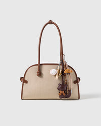 Cocoa Cat Baseball Stack Charm attached to a structured handbag to show the complete design