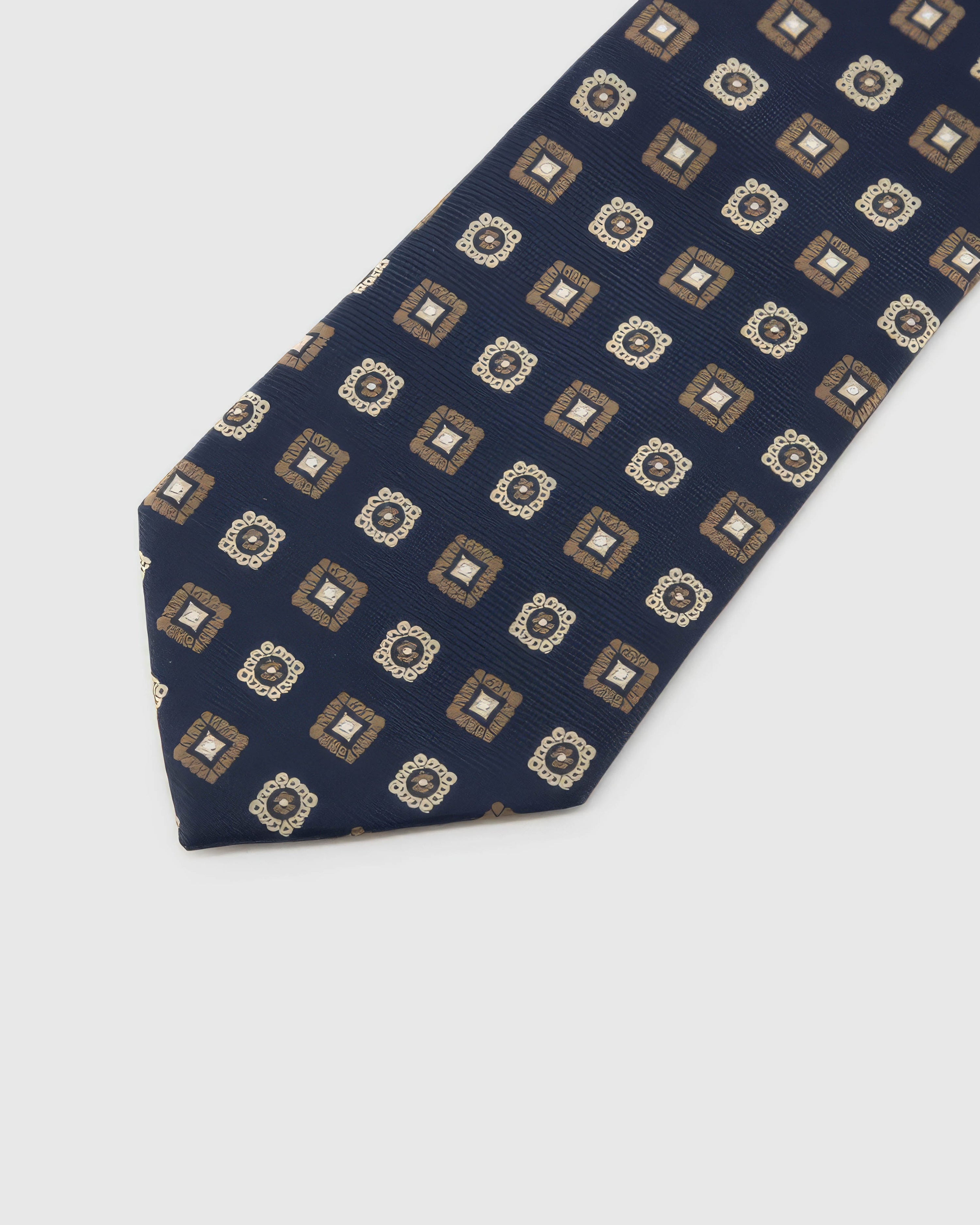 Navy Medallion Tile Tie blade detail showing hand-embroidered alternating tiles and rosette medallions and silk texture by STICKYZOO