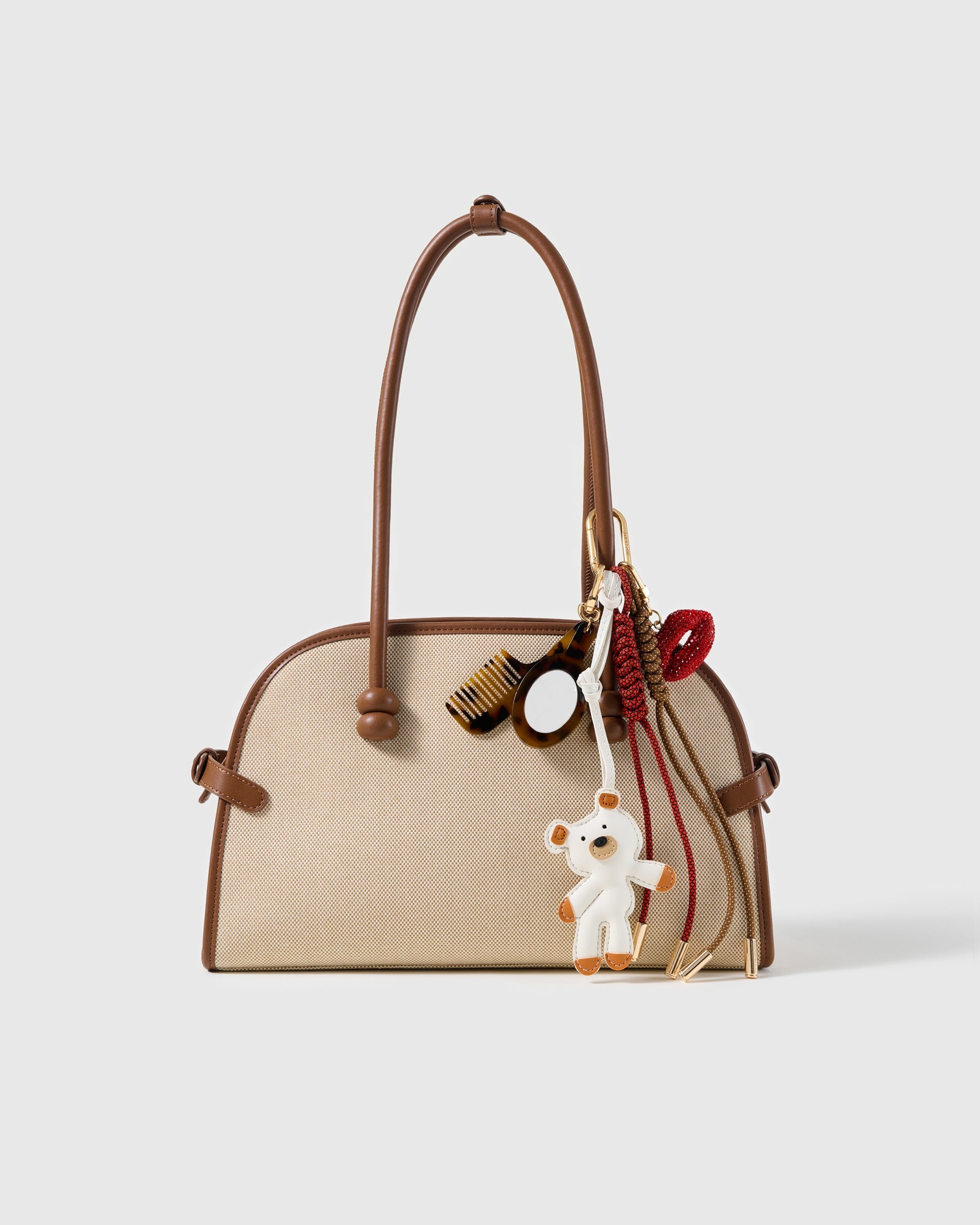 Glam White Pup Beauty Stack Charm attached to a structured handbag to show the complete design