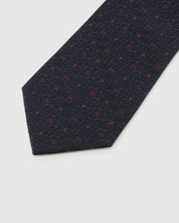 Onyx Crimson Tile Tie blade detail showing hand-embroidered crimson micro tiles and bronze dots and silk texture by STICKYZOO