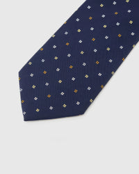 Midnight Quatrefoil Tie blade detail showing hand-embroidered gold, amber and ivory quatrefoils and silk texture by STICKYZOO