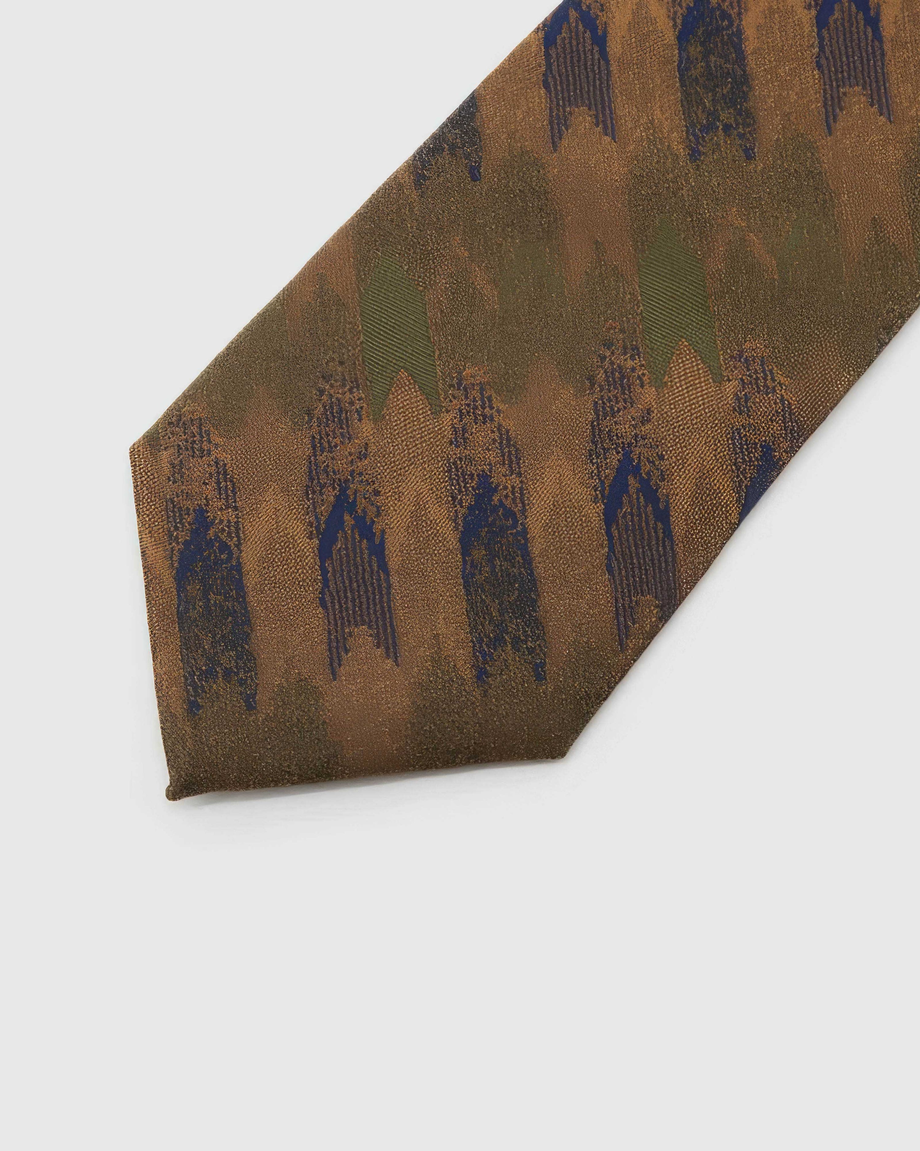 Amber Brushwork Tie detail showing amber and walnut brushwork with navy, olive, rust and tan and the tactile silk surface.