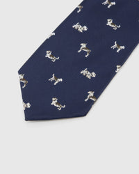Midnight Dog Parade Tie detail showing midnight ground with ivory, taupe and chestnut dog silhouettes and the tactile silk surface.