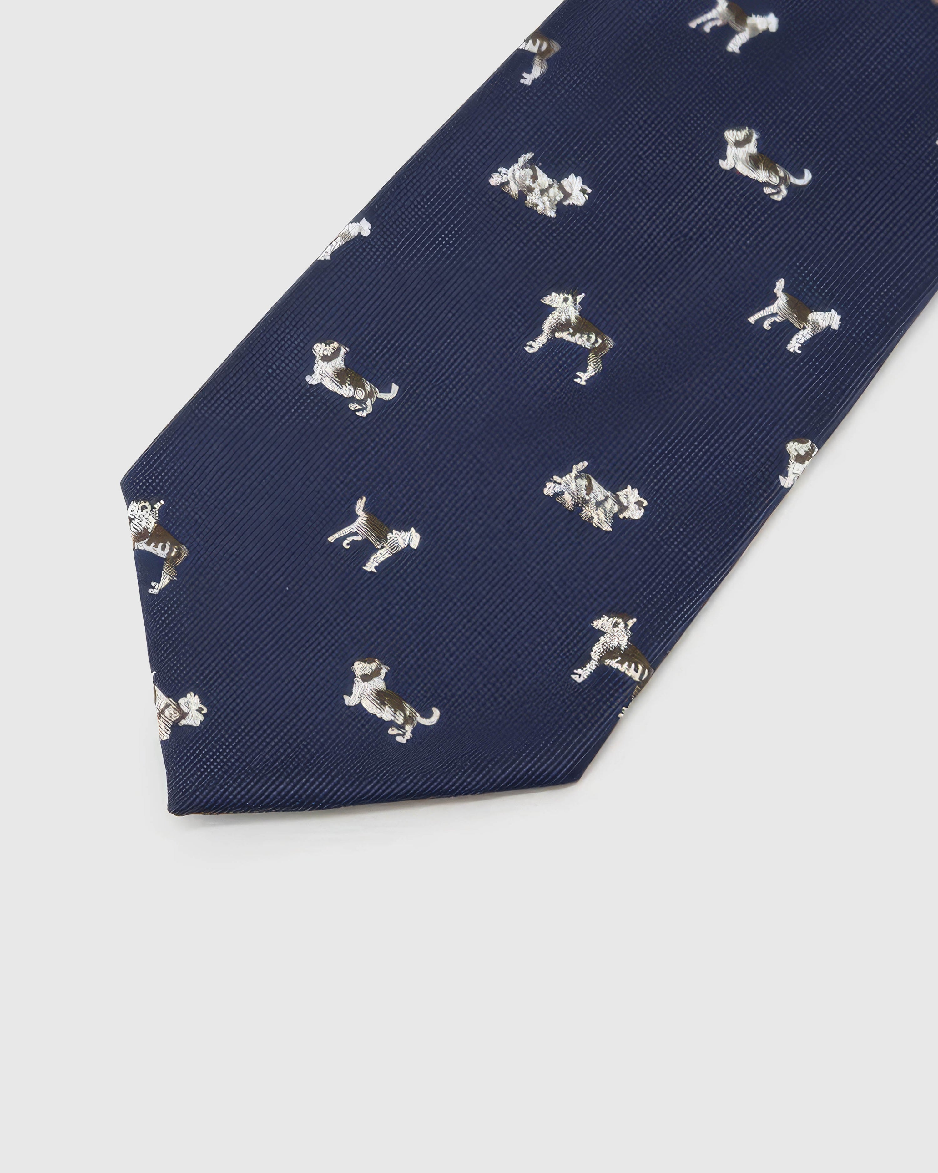 Midnight Dog Parade Tie detail showing midnight ground with ivory, taupe and chestnut dog silhouettes and the tactile silk surface.