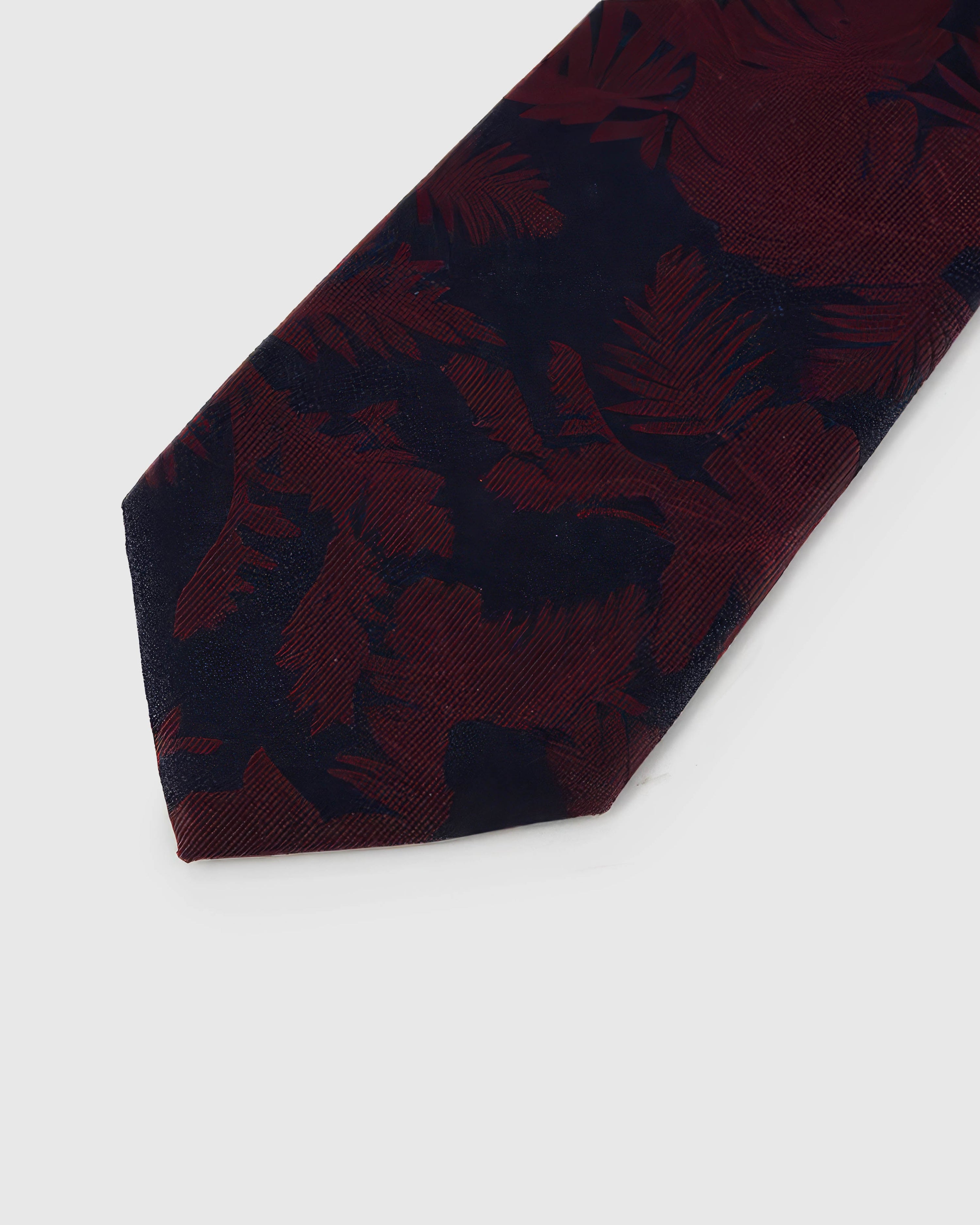 Midnight shadow blooms across claret crosshatched silk, hand-embroidered with raised thread by STICKYZOO