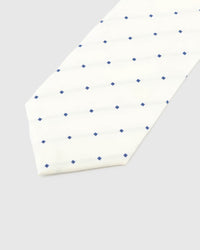 Ivory Navy Square Tie detail showing ivory ground with spaced navy squares and tonal lines and the tactile silk surface.