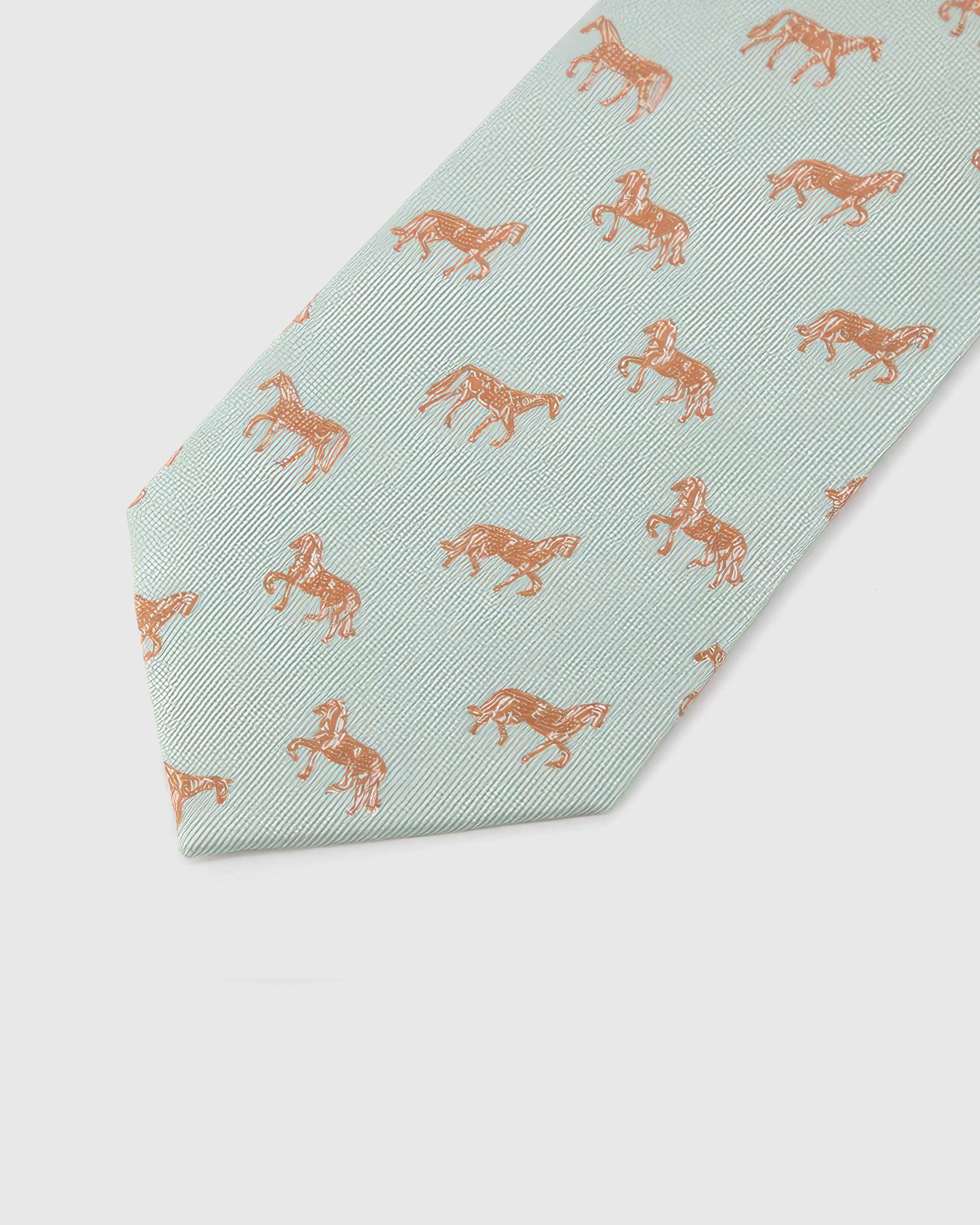 Celadon Copper Horse Tie blade detail showing hand-embroidered mixed copper horse illustrations and silk texture by STICKYZOO